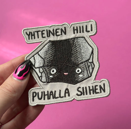 Yhteinen hiili, puhalla siihen - Kangasmerkki